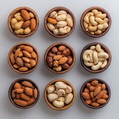 A minimalistic top view of mixed nuts in handcrafted wooden bowls, scattered across a neutral-colored background. 