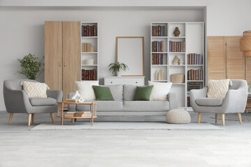 Interior of modern living room with bookcases, sofa, armchair and coffee table