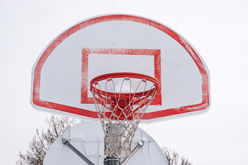 Outdoor basketball hoop in winter after snowstorm