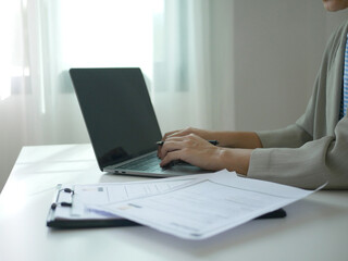 Young businesswoman holds a resume and evaluates it. Views the personal history of job applicants. Recruitment concept