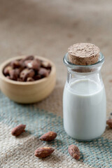 Almond milk on wooden background
