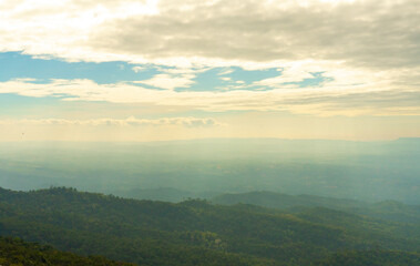 Naklejka premium View of Mountain Tops on a Warm Summer Day – Clouds in the Sky Over the Way to Phu Hin Rong Kla and Phu Lom Lo. Scenic Landscape of Phitsanulok, Thailand. Nature, Travel, and Adventure Destination.