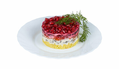 A white plate topped with a delightful cake and pomegranate seeds