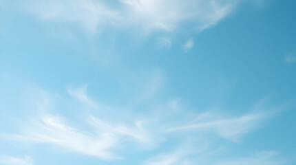 serene blue sky filled with soft, wispy clouds. Ideal for nature and peaceful sky imagery