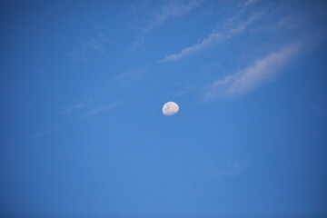 Low angle view of moon in blue sky