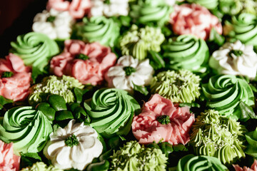 Cropped close up of succulent wedding cupcake display