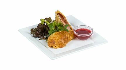 Chicken fillet baked under a cheese crust with salad and red sauce on a plate on a white background