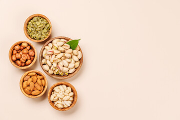 A vibrant assortment of various nuts, including almonds, walnuts, hazelnuts, cashews, and pistachios