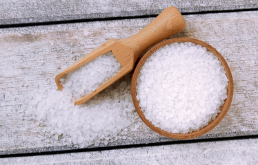 Sea salt on a wooden table. Coarse sea salt for cooking.