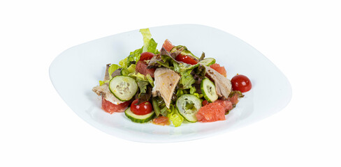 Fresh diet salad with meat, cucumber and grapefruit on a plate on a white background