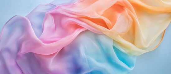Obraz premium Pastel rainbow fabric draped on blue background