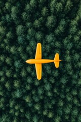 Aerial View of a Bright Yellow Aircraft Flying Above a Dense Green Forest Canopy