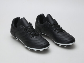 Black color football shoe isolated on light background