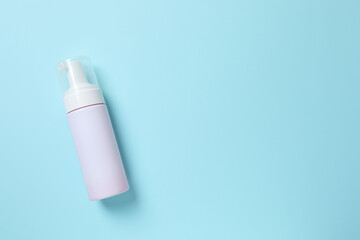 Natural cosmetic products. Cosmetic bottle on a blue background, top view