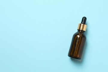Natural cosmetic products. Cosmetic bottle on a blue background, top view