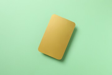 Golden paper card on color background