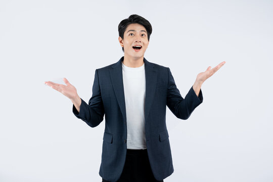 Portrait of young Asian business man posing on white background