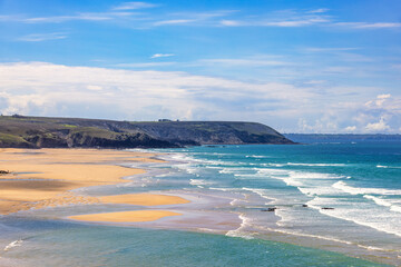 Breaking waves at a sea beach a sunny summer day in Bretagne