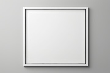 blank white picture frame on wall with shadow on grey background