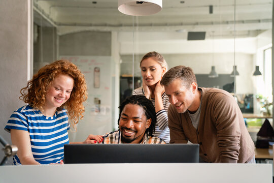 Smiling diverse colleagues gather in boardroom brainstorm discuss financial statistics together