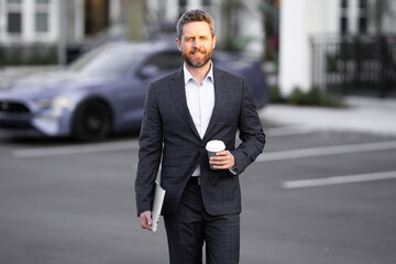 Portrait of a confident business man walking in city. Bandsome business man in casual suit walking at street. Business man walking in formal suit. Attractive middle aged business man walking outdoor.
