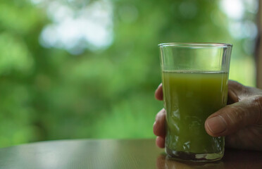 Senior man holding green juice. 青汁を手に持つシニア男性