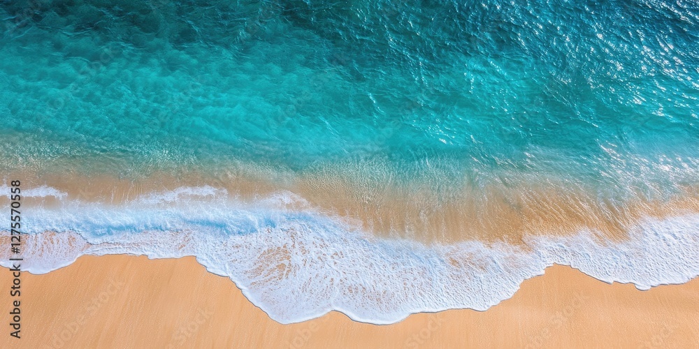 Poster Aerial view of a serene beach with turquoise waves gently lapping at soft golden sand, creating a tranquil coastal scene.