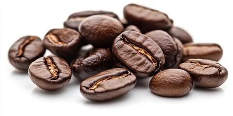 Fototapeta premium Close-up of roasted dark brown coffee beans scattered on a white background, showcasing their rich texture and natural shine.