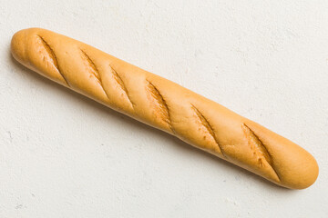 Minimalist french baguette on colored background. fresh bread as background, top view with space...