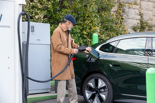 Older gentleman charges his electric car
