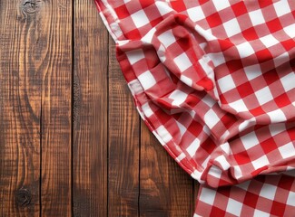 A red and white checkered tablecloth on a rustic wooden background, perfect for a cozy picnic or dining setting.