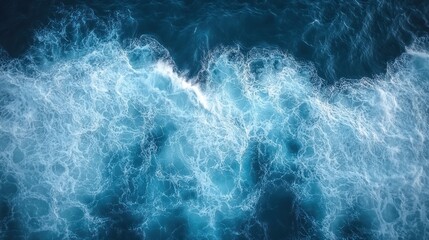 Fototapeta premium Ocean waves churning, aerial view, background deep blue