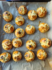 Homemade whole grain buns showcased, beautifully sprinkled with black  seeds.  Muffin. Baking a tray of cheese pastry  in the oven. Yolk Puff. Homemade Turkish Pastries Pogaca with Black Cumin.