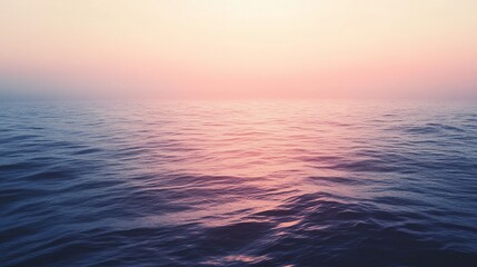 Obraz premium Serene ocean sunset, soft pink and purple hues.