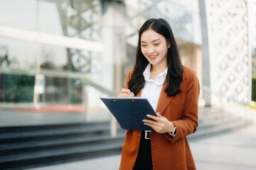 oung Asian business woman leader entrepreneur, professional manager holding digital tablet computer