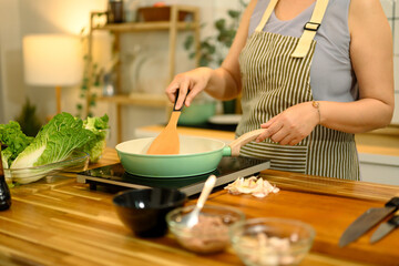 Middle aged woman preparing a healthy meal in the kitchen
