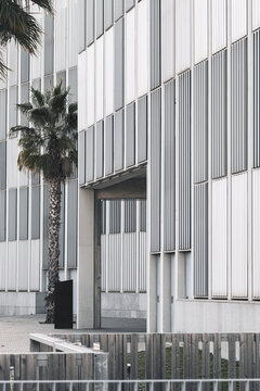 Side view of a modern building featuring vertical and horizontal structural elements.
