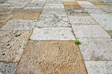 Old limestone medieval paving made with stone blocks of rectangular shape