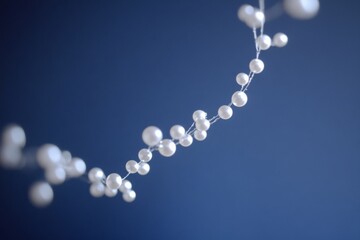 Delicate, white beads thread gracefully against a soft blue backdrop, creating an ethereal floating effect reminiscent of a serene sky.