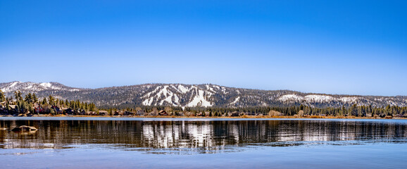 Panoramic photograph for big bear shore with snowy mountains in the background