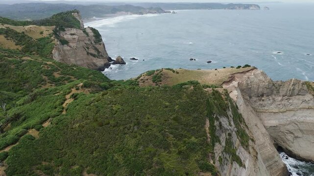 Aerial view of the cliffs and coastline near Muelle De Las Almas, a unique place in Chonchi, Chiloe Island, Chile. Parallax Shot