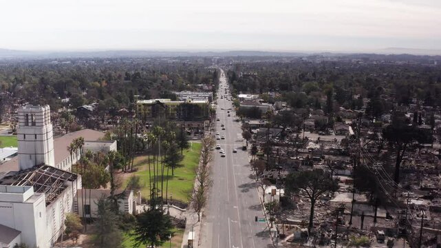 Low aerial shot flying south over Lake Street in downtown Altadena after the Eaton Fire. 4K