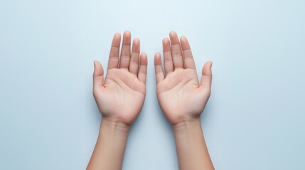 Pair of open hands on light blue background. Gesture of giving, help, and offering support