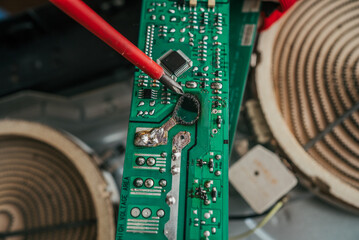 Technician closely examining burnt electronic circuit board, revealing intricate damage and...