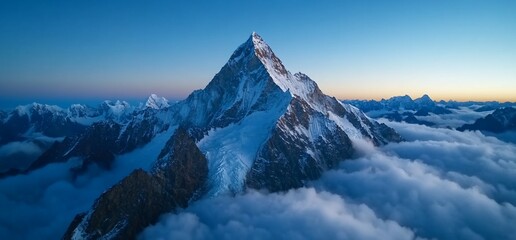 Majestic Mountain Peak Pierces Through a Sea of Clouds at Dawn's Embrace