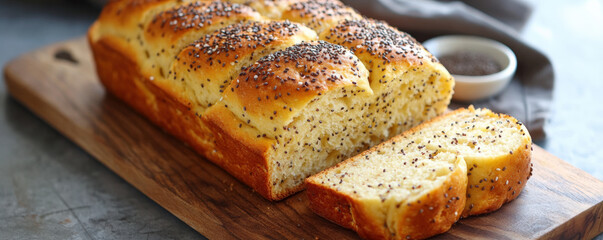 Freshly baked golden keto bread with chia seeds, sliced and served on wooden board, exuding warm and inviting aroma. Perfect for healthy meals or snacks