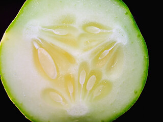 Macro of slices cucumber on black background, close-up of slices cucumber
