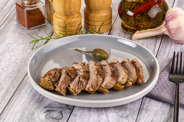 Roasted duck breast slices in the plate