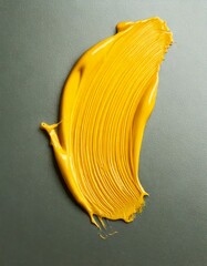 Mustard yellow paint strokes on a grey background 