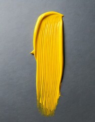 Glossy yellow paint stroke on a grey background , isolated, copy space 